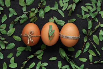 Brown eggs and green leaves Easter decoration
