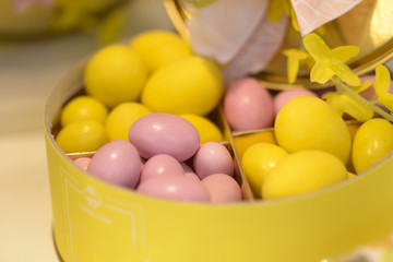 delicious chocolate eggs colored pink and yellow in their container