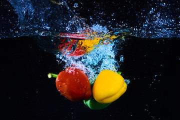 clean vegetables in the water with black background