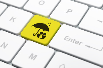 Protection concept: Family And Umbrella on computer keyboard background