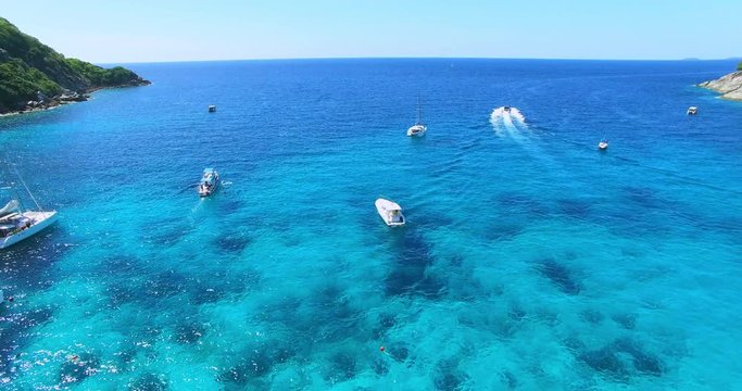 Racha Island Beach. Thailand, Phuket. Yachts , Catamarans and Boats sailing in crrystal clear blue water of ocean. Aerial view. 4K.