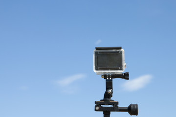 action camera on tripod with blue sky as background