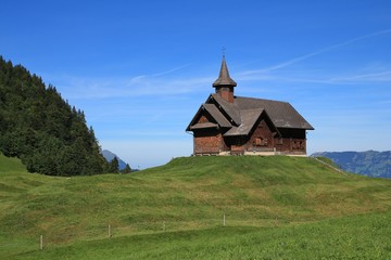 Fototapeta na wymiar Old timber chapel on a hill top in Stoos, Switzerland.