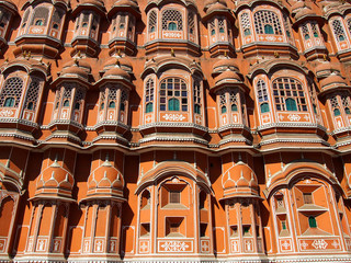 Fototapeta na wymiar The red Palace of Winds or Hawa Mahal facade facing the streets of Jaipur India.