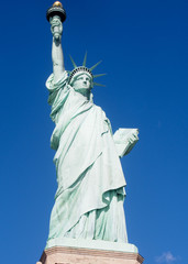 Fototapeta premium The Statue of Liberty on a sunny day in the harbor of New York City.