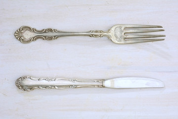 Vintage cutlery on rustic white board