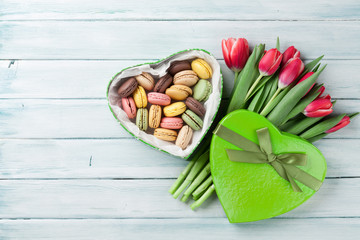 Red tulips and gift box with macaroons