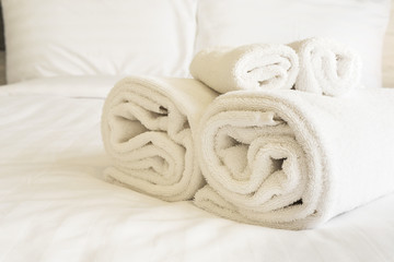 Obraz na płótnie Canvas White bedding and towel set in modern hotel