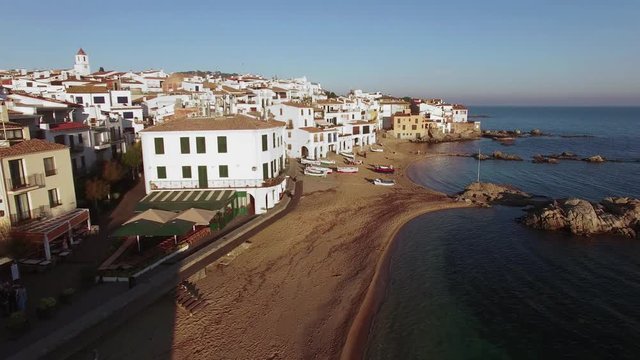 Fishing Village Aerial Shoot at Sunset.
Picturesque Mediterranean fishing village in la Costa Brava.
Aerial drone shot flying over the rooftops to the old center of Calella de Palafrugell.
