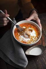 Butter chicken and a woman on a dark background partial blur