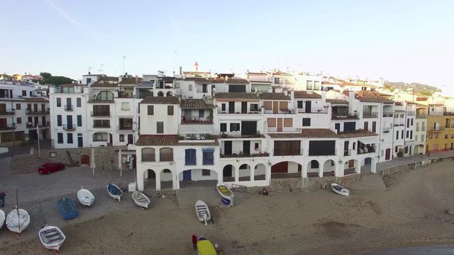 Mediterranean Village Vertical High Aerial Shoot.
Picturesque Mediterranean fishing village in la Costa Brava.
Aerial drone shot flying high and higher over to the old center of Calella.
