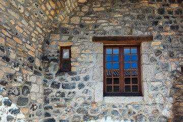 Window in an old basalt wall in the picturesque village of Mirabel Ardèche, France.