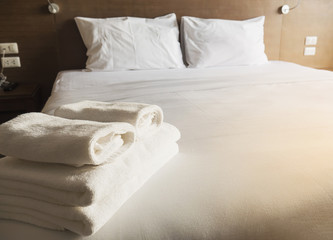Fototapeta na wymiar White bedding and towel set in modern hotel