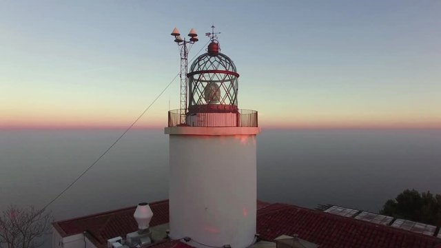 Maritime Lighthouse Aerial Shoot View at Sunset.
Mediterranean maritime lighthouse next to the sea.
Colorful horizon over the ocean.
Awesome sunset over the Mediterranean Sea.
