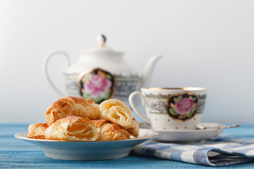 croissant and tea in mug. Breakfast concept