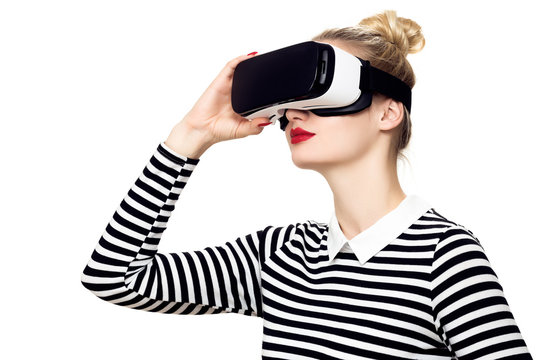 Fototapeta Attractive woman wearing virtual reality glasses. VR headset. Virtual reality concept on white background.