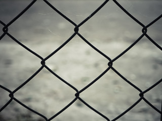 Rusty steel wire mesh fence.