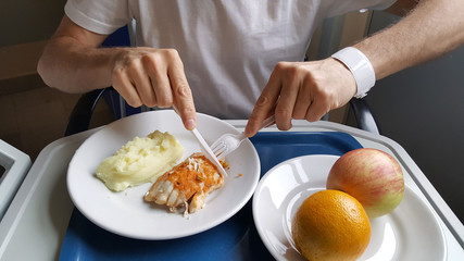 Man eating hospital food