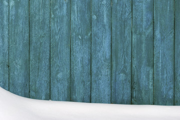 Wooden fence covered with snow.
