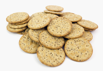 Shallow focus on pile of wheat crackers. Isolated.