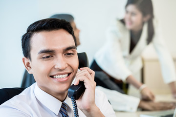 Employee in office making a business call