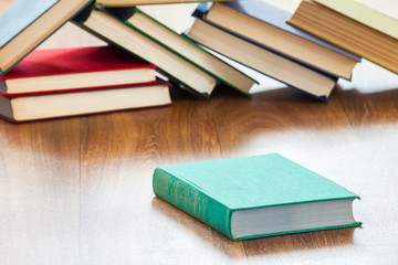 Books lie on a wooden table.