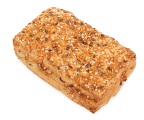 Spicy bun sprinkled with sesame seeds, isolated on white. Close-