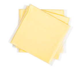 Three yellow cheese slices packaged on white background. Close-u