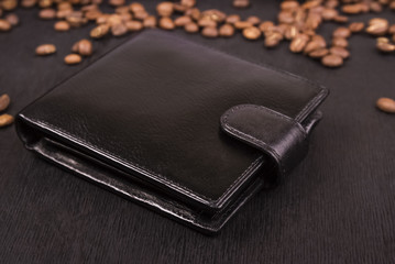indoor black leather purse on a black wooden background