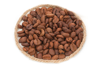 Roasted coffee beans pile from top with decorative rope, twine,