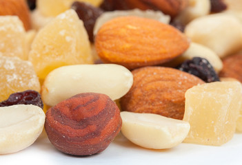 Mixture of nuts and candied fruits isolated on a white backgroun