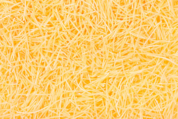 Pasta noodles background close up top view.