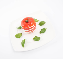 Caprese salad - tomato with mozzarella, decorated with basil