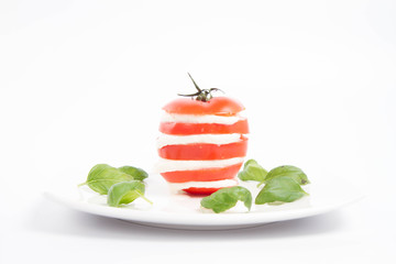 Caprese salad - tomato with mozzarella, decorated with basil