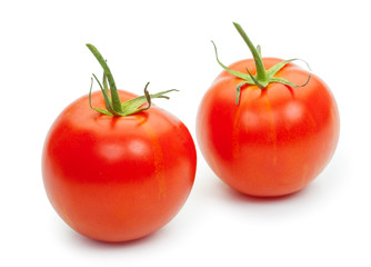 Two fresh tomatoes with green leaves isolated on white backgroun