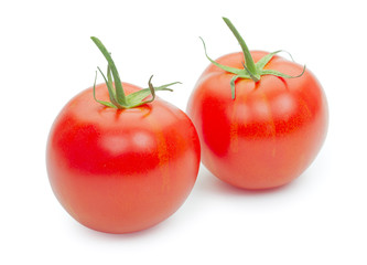 Pair of fresh tomatoes with green leaves isolated on white backg