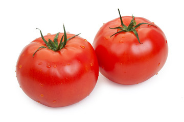 Pair of red tomatoes with drops of water isolated on white