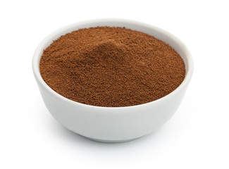 Chicory powder in a in white ceramic bowl. Isolated on white bac