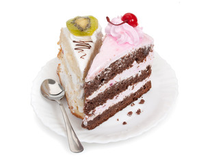 Two pieces of tasty cake on white saucer with teaspoon, chocolat