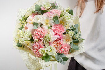 beautiful bouquet made of different flowers with in woman hand . colorful color mix flower
