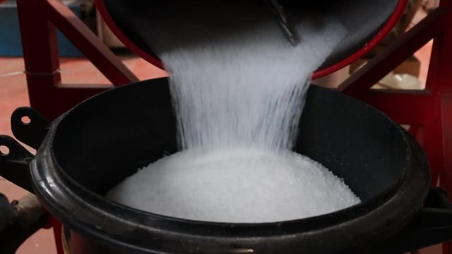 Pouring polyethylene plastic material into container