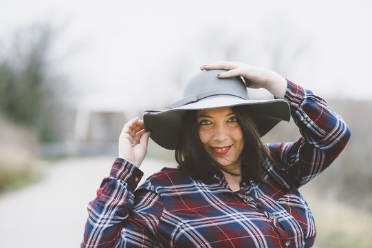 Portrait of chubby girl with hat in the field