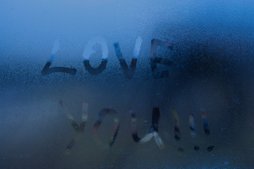 The words "I love you" written on the window