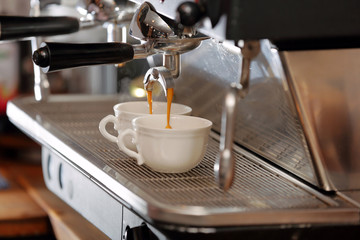 Espresso machine making cappucino cup of coffee