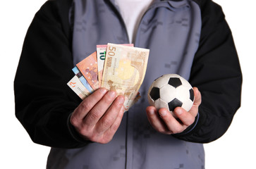 Soccer ball and money in hand