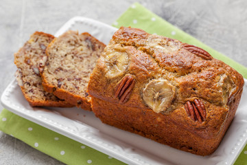 Sliced banana bread with a pecan