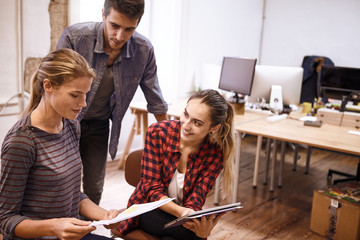 Fototapeta premium Team of three young professionals smiling