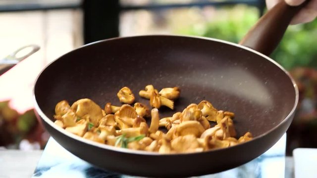 Flipping Food In A Pan. Chanterelles With Garlic And Rosemary.