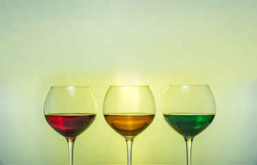 Three glasses with colorful drinks red, yellow, green