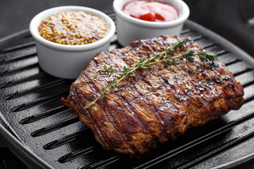 cooked steak on grill pan